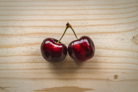 A photo of two ripe cherriesの写真素材