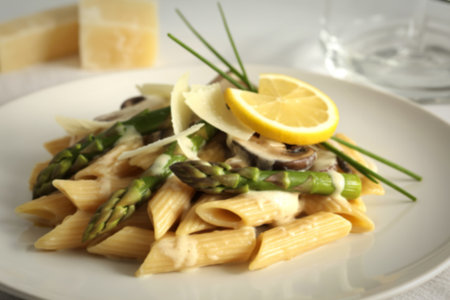a bowl of penne pasta with asparagusの写真素材