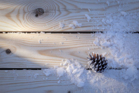 a weathered wooden deck blanketed in fresh snow.の写真素材