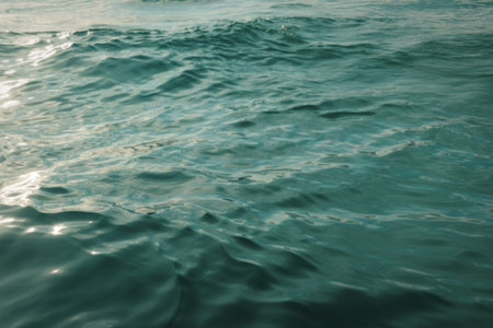 A photograph of intensely blue ocean water with a dynamic rippled surfaceの写真素材