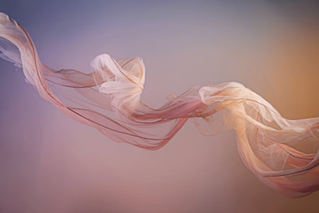 flowing pattern of light pink and peach-colored fabricの写真素材