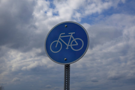 A photo of a round blue sign with a white bicycle symbolの写真素材