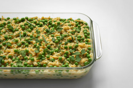 rectangular glass dish filled with a colorful creamy rice dishの写真素材