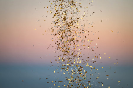 A shimmering golden confetti cascading through the air