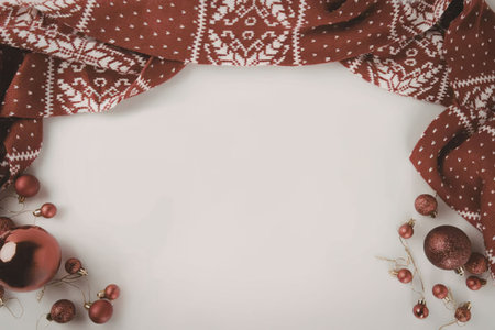 A festive holiday border featuring red and white patterned fabric, Christmas ornaments on a white background.の写真素材