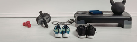 A collection of fitness equipment for home workouts including dumbbell, resistance band, jump rope,...