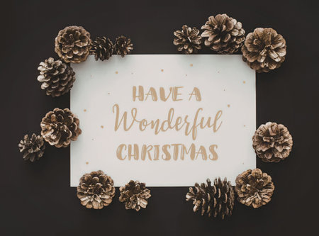 A Christmas greeting card with pinecones and gold text on a white background