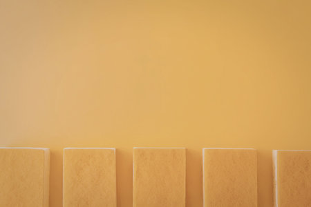 A row of orange blocks on a yellow background, simple geometric shapesの写真素材