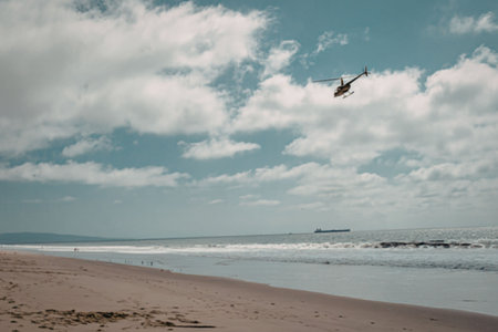 A helicopter flying over the beach