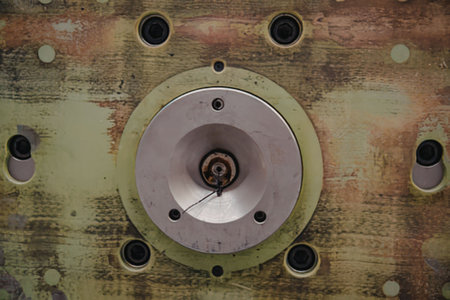 Close up of a green metal plate with bolt