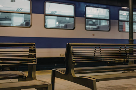 Empty train station seats waiting for passengersの写真素材