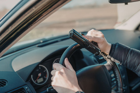 Person using phone while driving a carの写真素材