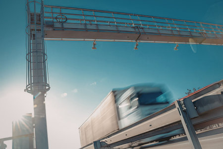 Truck drives under industrial crane