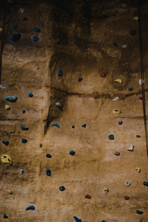 Indoor rock climbing wall with colorful handholds