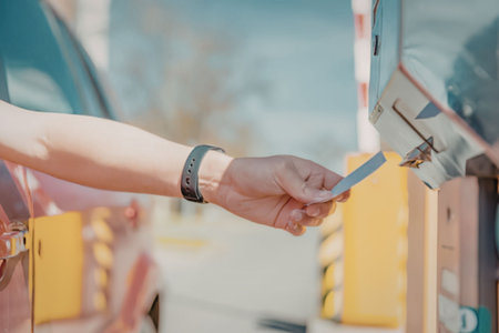 Person using parking meter with card