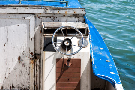 wheel of an old boat stops at the port