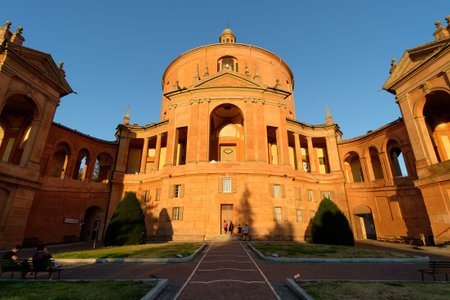 Bologna, Italy - August 25, 2016: Tourists at sunset in front of the facade of the Catholic Cathedral of St. Luke on a hillside of Bologna, Italy.のeditorial素材