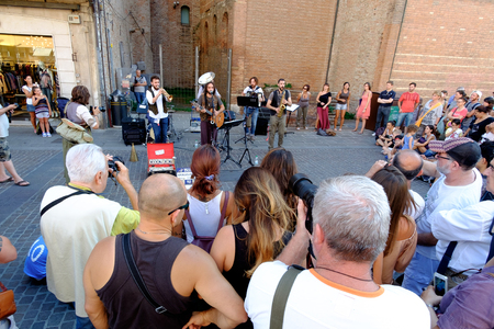 FERRARA, Italy - August 27, 2016: Buskers Festival 2016 in Ferrara, Emilia Romagna, Italy. Busker Festival is a popular event with street artists which is held annually in the historic center of Ferrara.In the picture a musician playing the accordionのeditorial素材