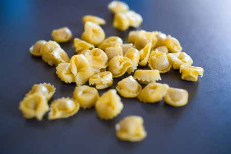 Tortellini, typical pasta of Bologna, Italy, filled with meat and spices, which is cooked with...