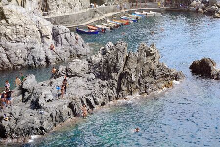 Manarola, Italy- September 17, 2018: Bathers in the Ligurian sea in the Cinque Terre village in summerのeditorial素材