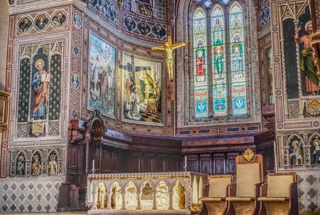 Gubbio, Italy - 11 August, 2019: Santi Mariano e Giacomo Church in Gubbio, Umbria, Italy with the wooden Christ, above the altar, of the Umbrian school of the thirteenth centuryのeditorial素材