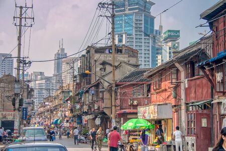 Shanghai, China - October 18 2006: Old and untidy district of the city, with skyscrapers in the modern district in the backgroundのeditorial素材