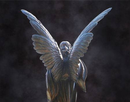 Dark portrait of a Basilica de San Miniato angel from back with large, beautiful silvery white wings extended over dark misty background.のeditorial素材