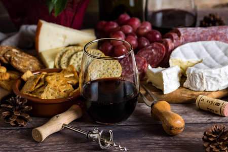 Stemless wine glass and cheese spread.の写真素材