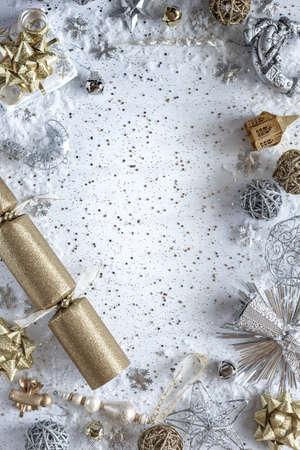 A top down view of gold and silver Christmas decorations forming a border or frame with copy space in the middle.の写真素材