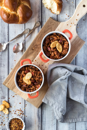 A top down view of two bowls of Chili Con Carne on a wooden board ready for eating.の写真素材