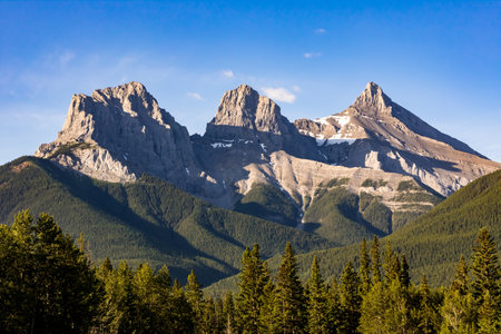 View of the Three Sisters Mountain peaks, a popular well known landmark near Canmore, Alberta Canada.の写真素材