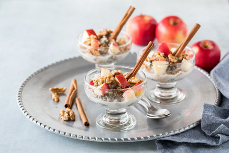 A close up of glass dishes filled with steel cut oats, chia seeds and hemp seeds topped with chopped...