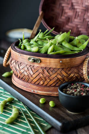 Close up view of a wicker basket filled with edamame beans ready for snacking.の写真素材