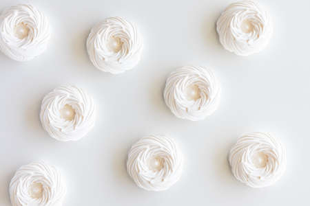 A top down view of several meringues against a white background.の写真素材