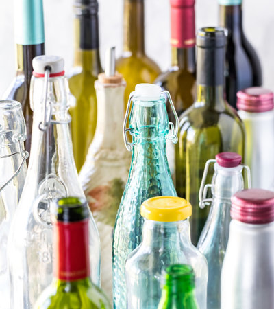 A close up view of various bottle tops against a bright background and lit from the left side.の写真素材