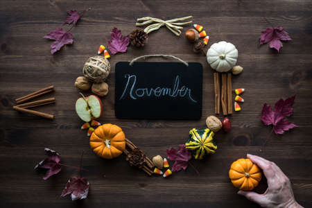 Various autumn and Thanksgiving decorations in a wreath motif against a dark background.の写真素材