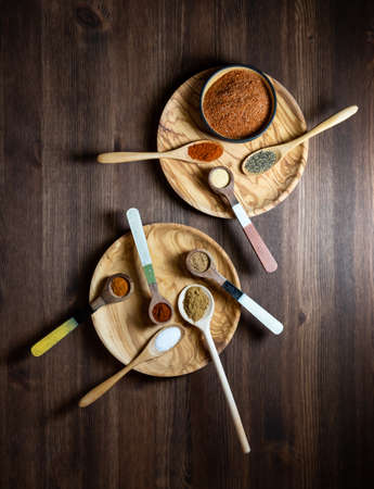 Top down view of wooden spoons of various spices used to make a southwest spice blend.の写真素材