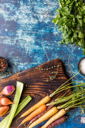 Top down view of a cutting board topped with ingredients used to cook mirepoix and copy space above.の写真素材