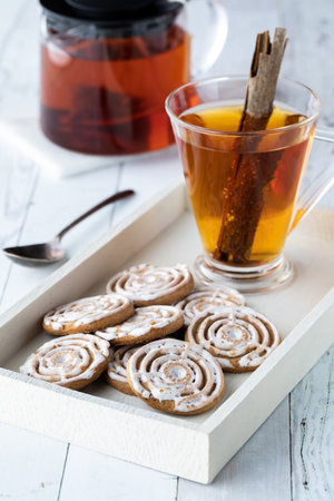 A tray of cinnamon swirl cookies with cinnamon chia tea ready for snacking.