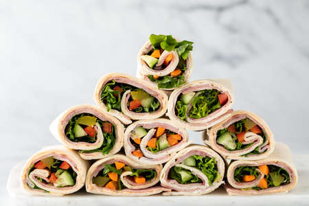 Freshly made deli wraps piled up in the shape of a pyramid.の写真素材