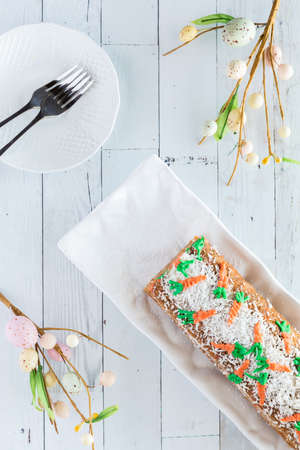 Top down view of a carrot cake jelly roll with plates ready for serving.の写真素材