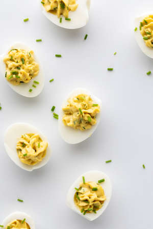 Top down view of several deviled eggs against a white background.の写真素材