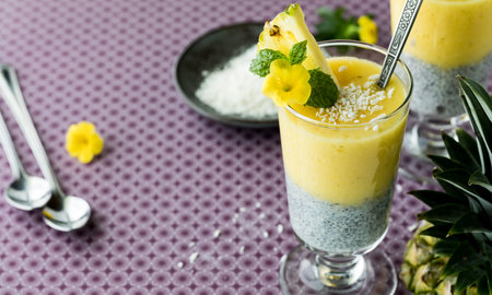 Chia and pineapple puree served with coconut flakes, ready for eating.