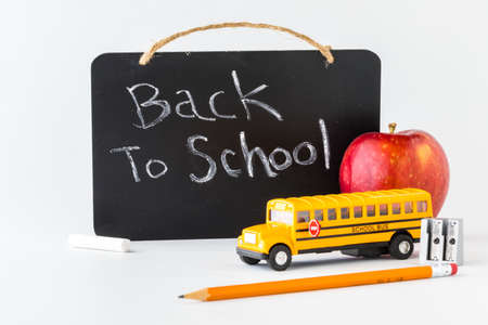 A chalk board with a message and items in front all to depict back to school.の写真素材