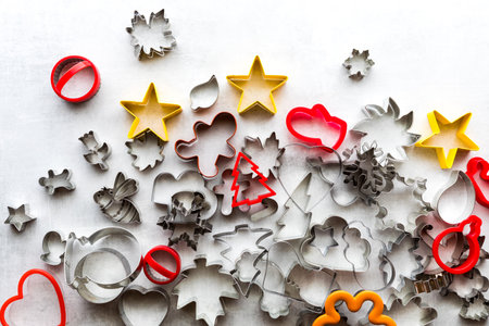 Top down view of many assorted cookie cutters against a light background.の写真素材