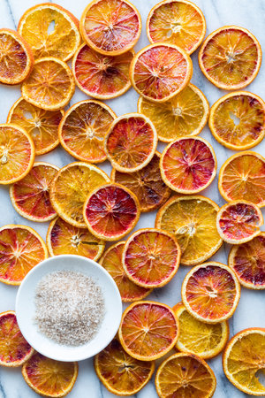 Many dried orange slices sprinkled with cinnamon and sugar.