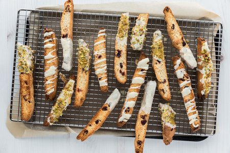 Pieces of homemade cranberry and pistachio biscotti on a cooling rack.の写真素材