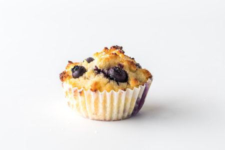 A single isolated homemade blueberry muffin against a white background.の写真素材