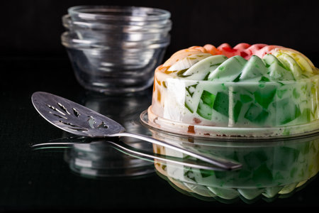A rainbow coloured fruit flavoured jelly mold dessert, ready for serving.の写真素材