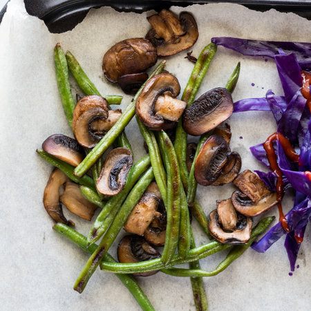 A mixture of sauteed beans and mushroom on parchmentの写真素材